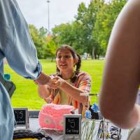 Student handling items during Student Small Business Market.